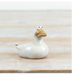 Charming hand-crafted ceramic duck with playful wide-eyed charm