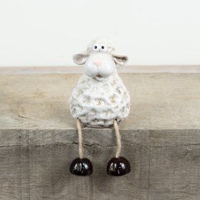 a charming rustic sheep figure with playful dangling legs