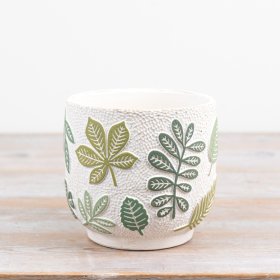 Elegant cream cement planter with raised green leaf designs, perfect for any plant enthusiast