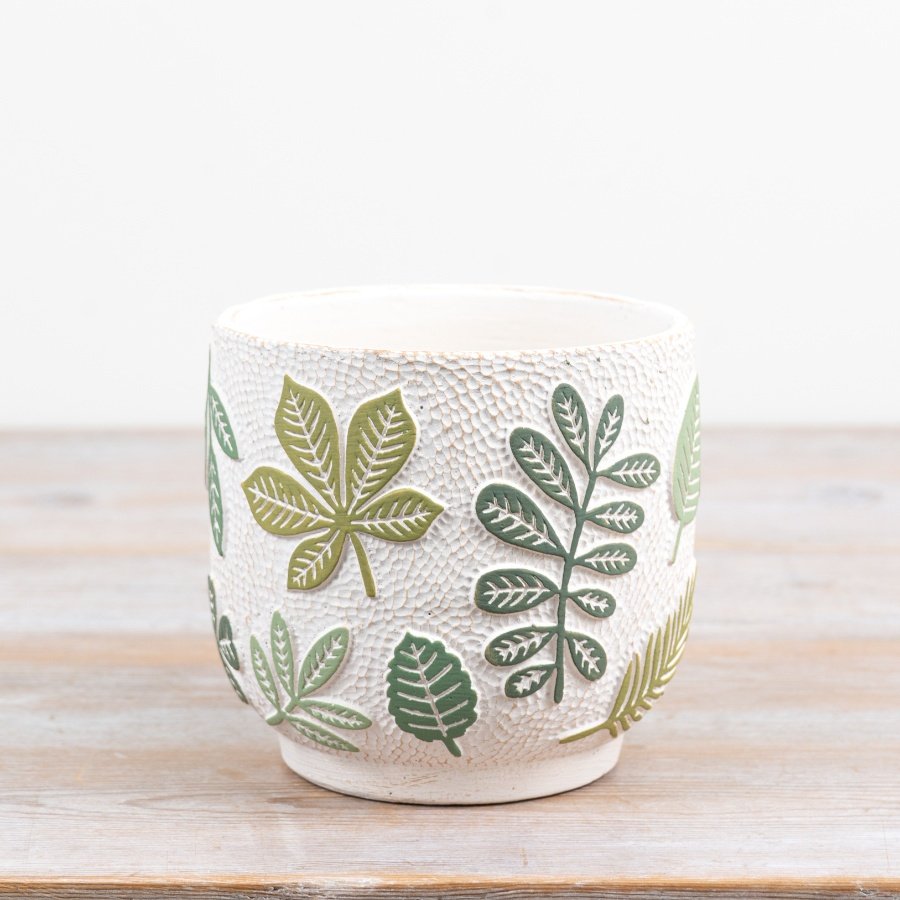 Elegant cream cement planter with raised green leaf designs, perfect for any plant enthusiast