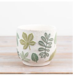 An elegant ceramic plant pot embossed with leafy designs, perfect for plant enthusiasts