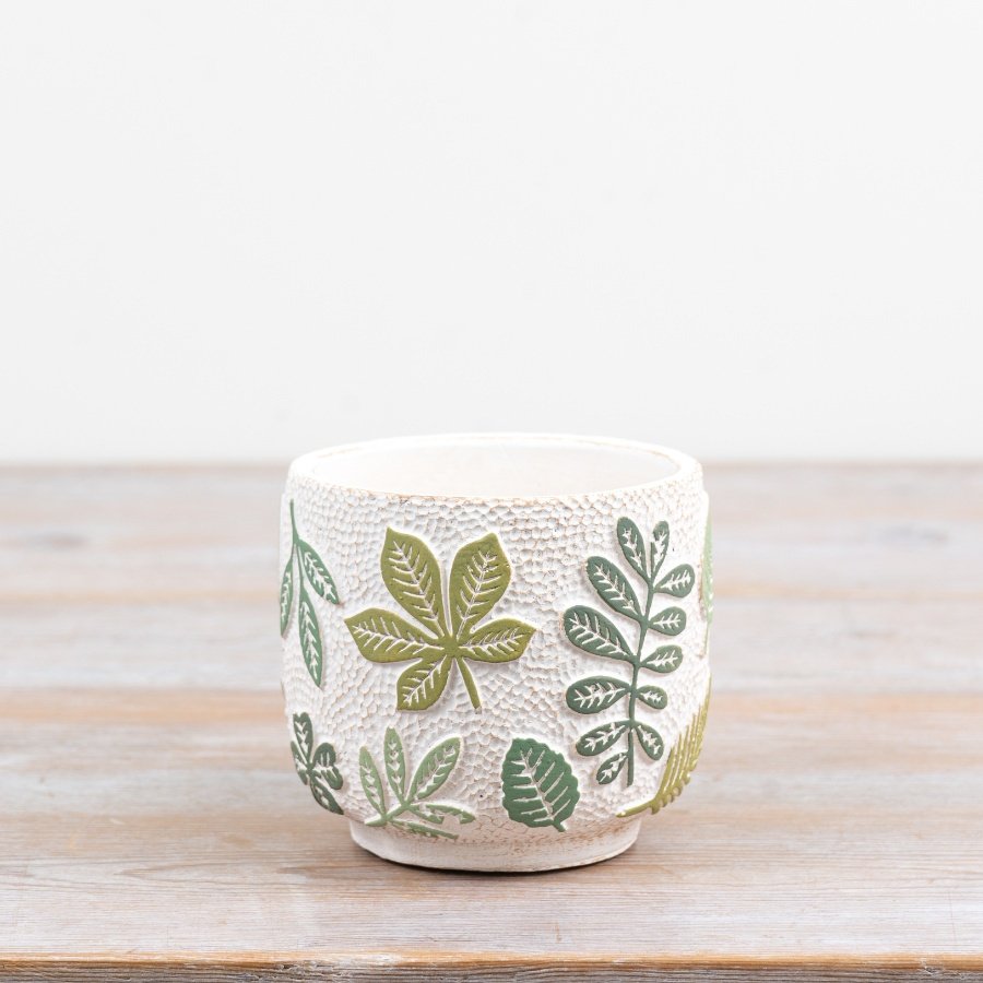 Introduce peaceful greenery indoors with this charming leaf-patterned plant pot