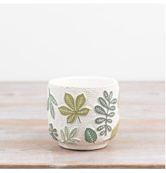 Brighten your space with this nature-themed plant pot showcasing graceful green leaves