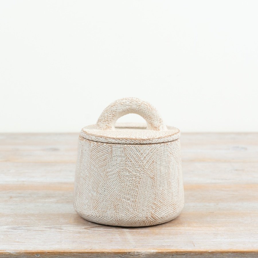 Enhance your home with this beautifully textured and sculptural cement pot featuring a practical lid