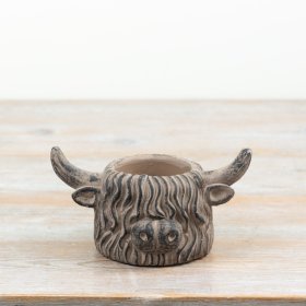 Rustic brown cement planter in a highland cow design for country-style interiors