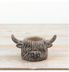 Charming brown cement planter shaped like a highland cow for rustic décor