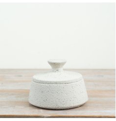 a sleek white storage jar with a matching lid to keep your small items neatly tucked away