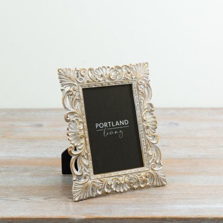 a elegant, vintage-inspired picture frame with an ornate, distressed finish