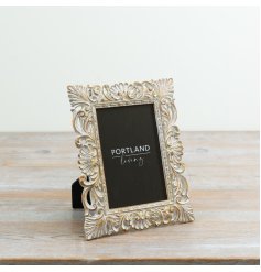 a elegant, vintage-inspired picture frame with an ornate, distressed finish