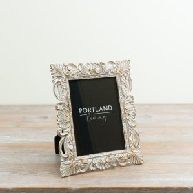a beautifully detailed vintage frame with ornate floral and scroll accents