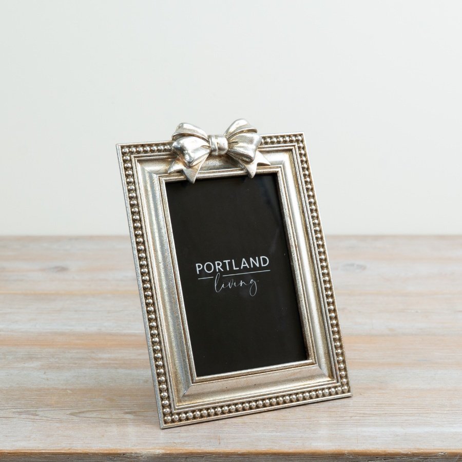 Chic silver photo frame adorned with a graceful bow detail