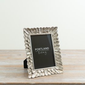 elegant feather-inspired frame with a sleek silver finish