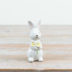 Charming bunny decoration holding a delicate flower bunch