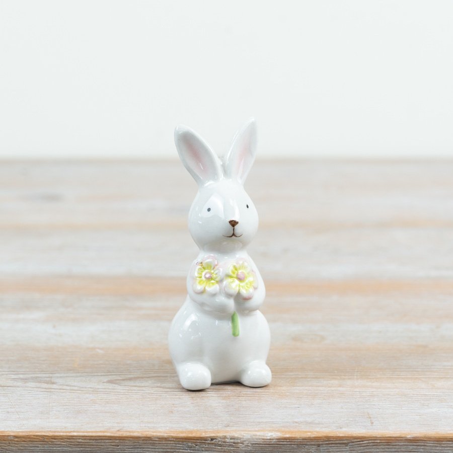 Charming bunny decoration holding a delicate flower bunch