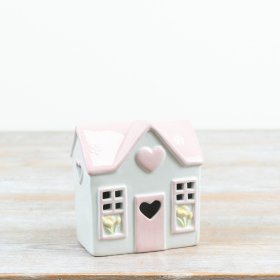 Sweet pastel house featuring a glowing heart to add warmth and charm to your decor