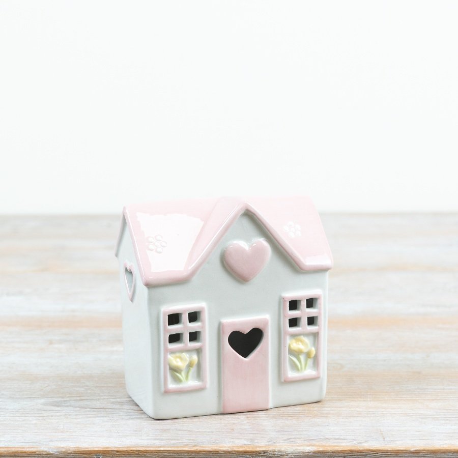 Sweet pastel house featuring a glowing heart to add warmth and charm to your decor