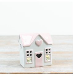 Charming pastel house with glowing heart detail to brighten any space