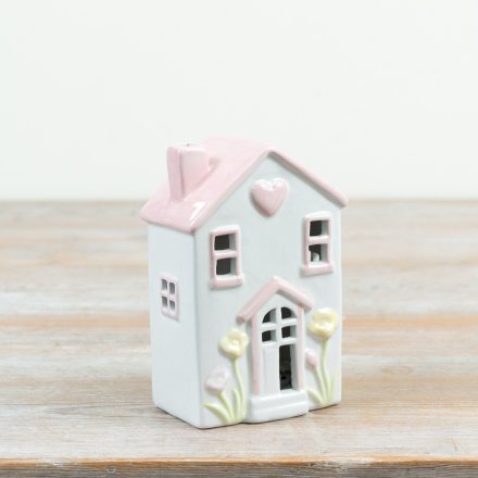 Light up your space with this delightful pastel ceramic cottage