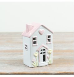 Light up your space with this delightful pastel ceramic cottage