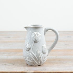 a charming small jug adorned with a raised tulip motif