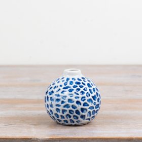 Add a breezy, seaside charm to your décor with this round ceramic bud vase