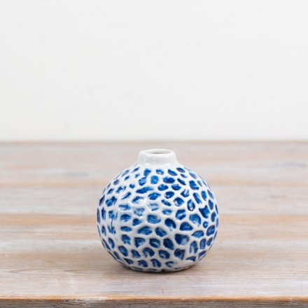 Add a fresh seaside charm with this round, ceramic bud vase featuring a delicate dimpled pattern
