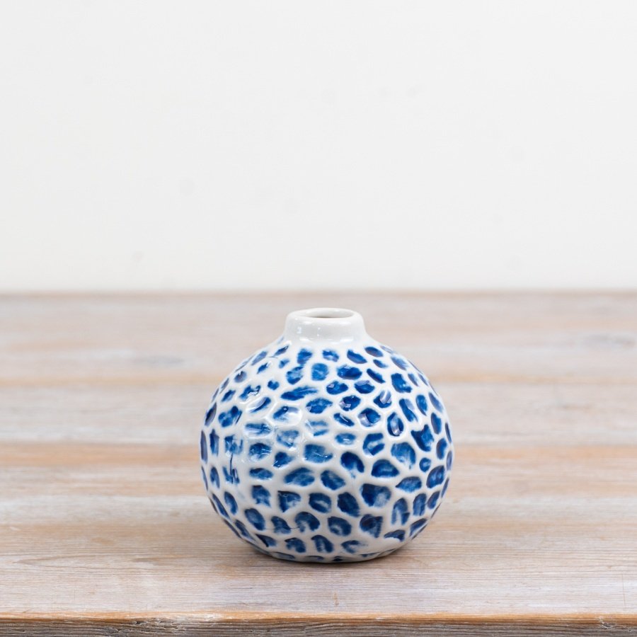 Add a breezy, seaside charm to your décor with this round ceramic bud vase