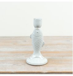 A charming fish candle holder in a white glazed finish.