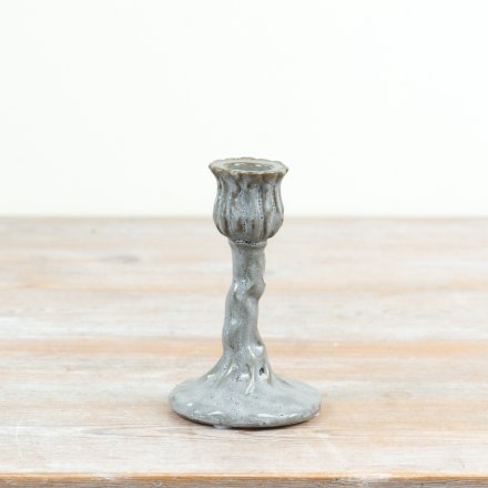 an elegant cup shaped like a flower bud perched atop a textured vine-like stem