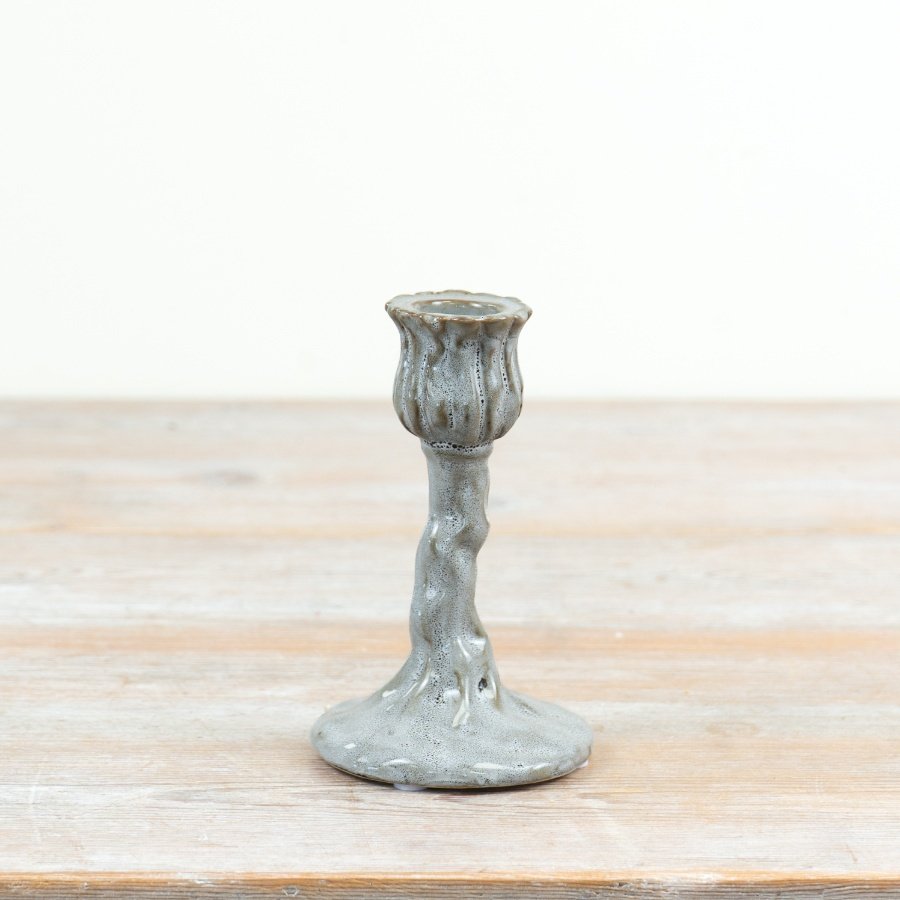 a charming bud-shaped cup perched atop a vine-textured, organic stem