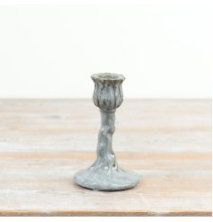 an elegant cup shaped like a flower bud perched atop a textured vine-like stem