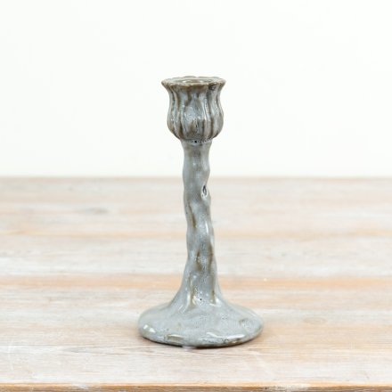 Tall candle holder featuring elegant flower bud and curved stem design