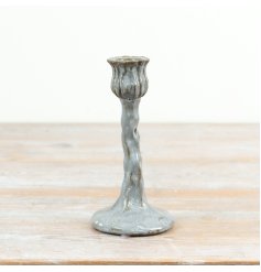 Tall candle holder featuring elegant flower bud and curved stem design