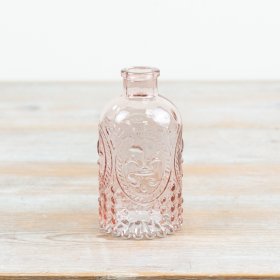 Delightful pink glass bottle vase with embossed detailing