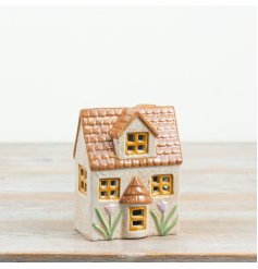 a glossy grey ceramic LED cottage adorned with floral motifs