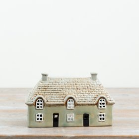Bring a cosy, inviting glow to your cherished corner with this delightful candle house