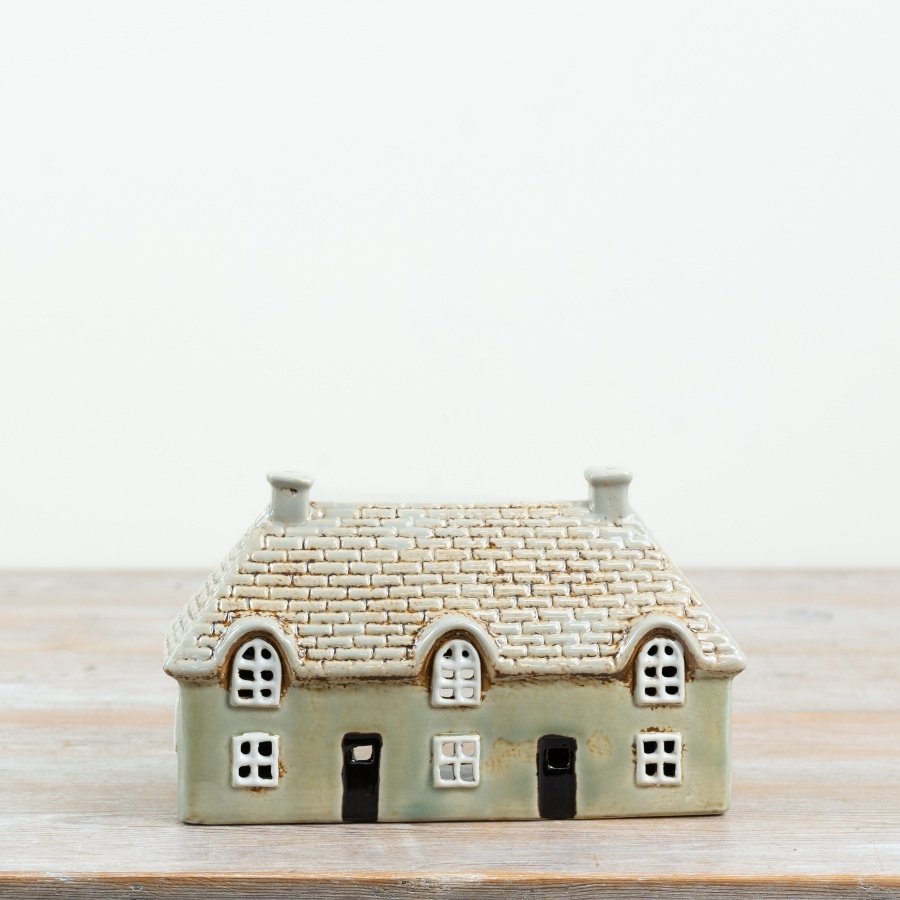 Bring a cosy, inviting glow to your cherished corner with this delightful candle house