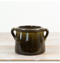 a dark forrest green shiny planter with handles 