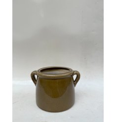 A glossy deep green planter with convenient handles for easy styling