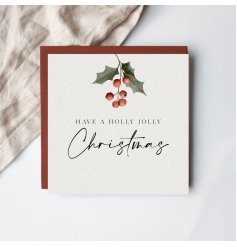 Send warm festive wishes with this charming holly-themed Christmas card