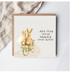 Delightful rear view of a bunny pair with flowing bridal veil and 'Just Married' sign on their bicycle