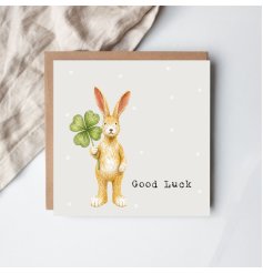 Charming hand-drawn Jasper rabbit clutching a lucky four-leaf clover