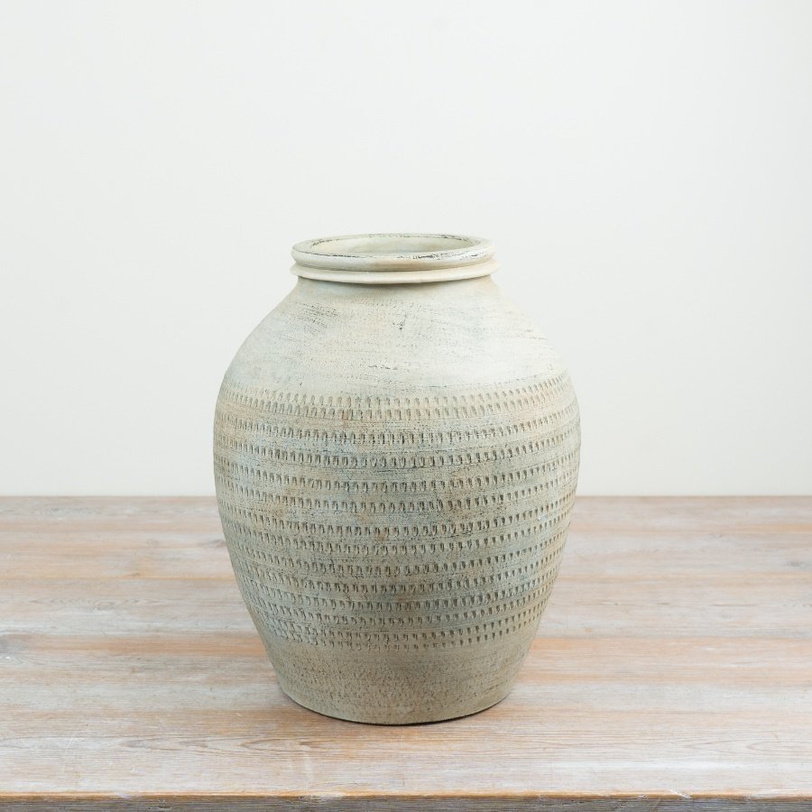 Embrace rustic charm with this timeless terracotta urn in natural tones