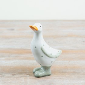 Delightful spotted duck figurine in bright yellow boots