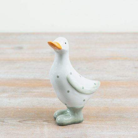 delightful polka dot duck figurine in cheerful yellow rain boots