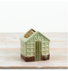 Charming house-shaped planter featuring window details, a green door, and an open top for your plants