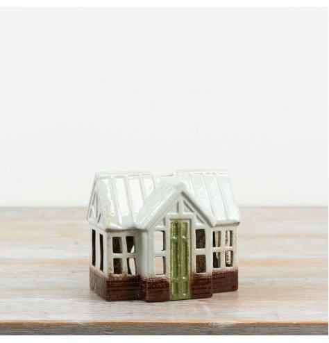 Bring a splash of colour and warmth to your home with this adorable tealight holder house