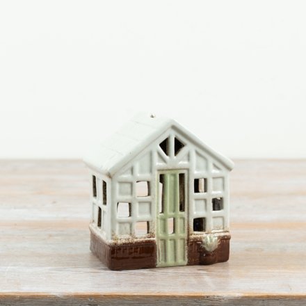 delightful green house tealight holder with intricate design