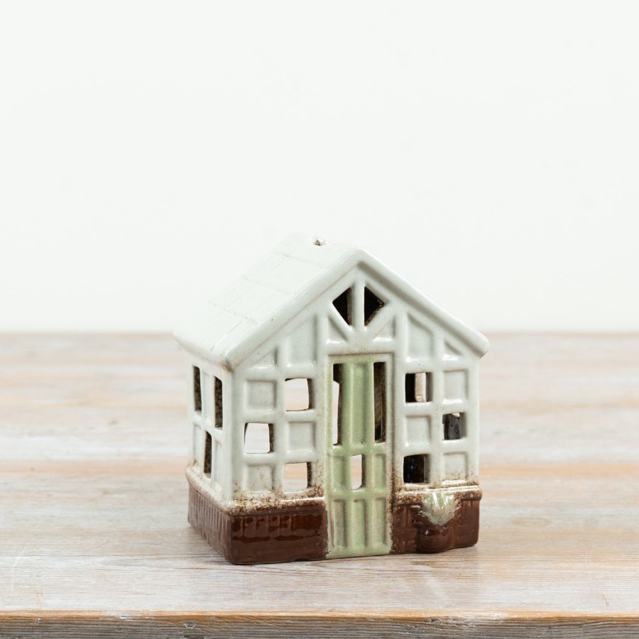 a delightful green miniature greenhouse tealight holder