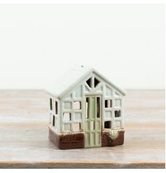 delightful green house tealight holder with intricate design